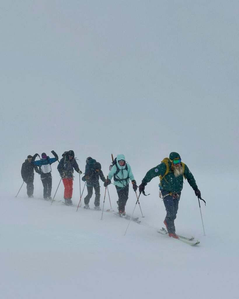 snowy adventure group skiing in harsh winter conditions